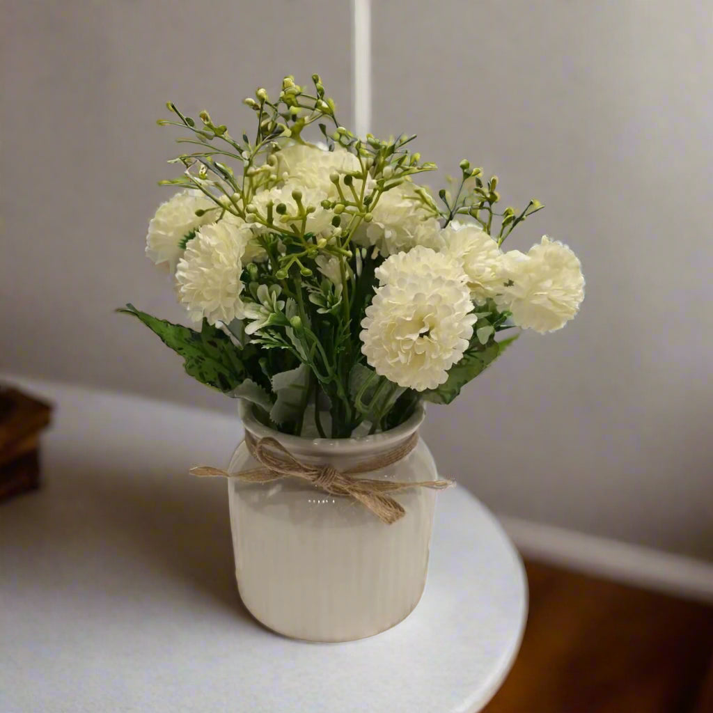 Pure Serenity: Artificial White Floral Arrangement in Ribbed Ceramic off-White Pot