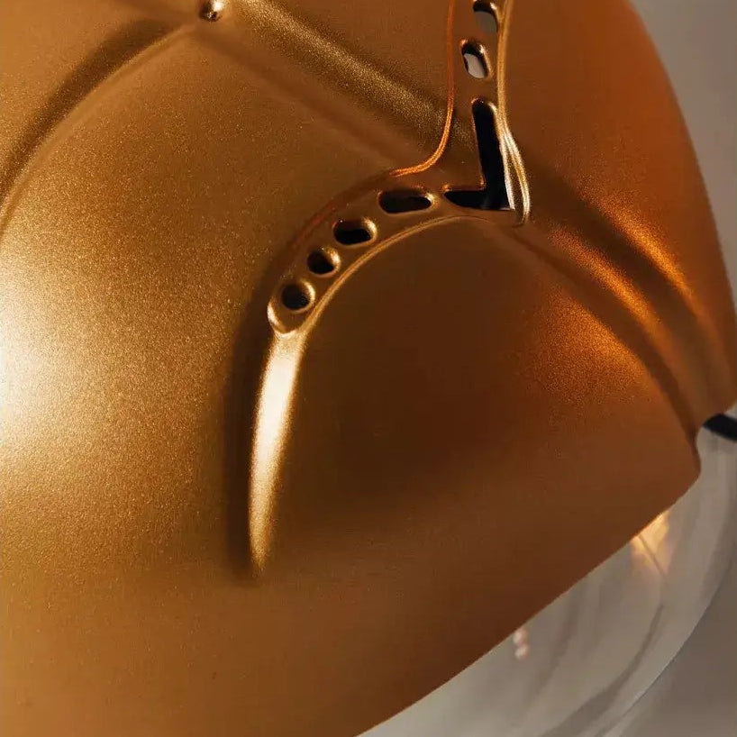Close-up of a gold helmet with a white background