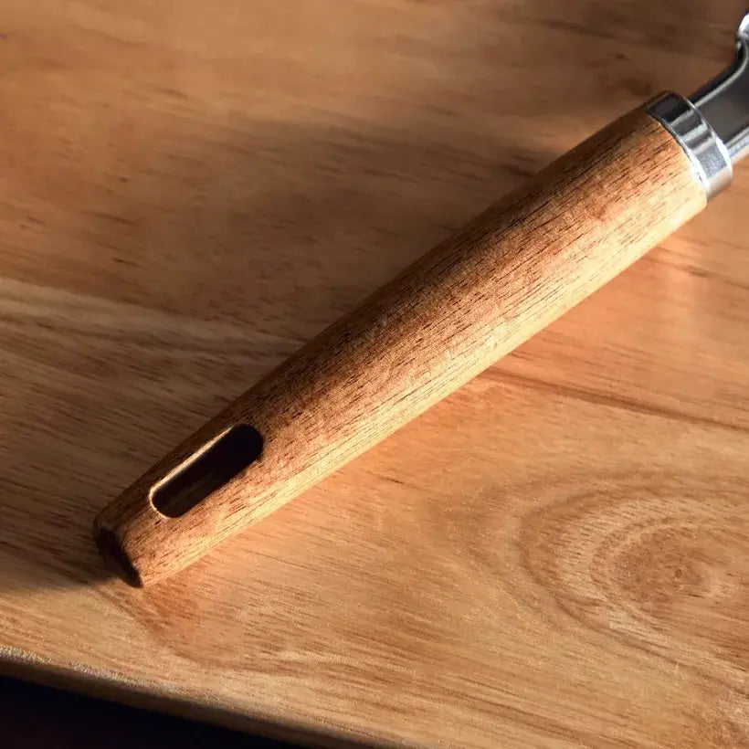 Wooden handle of a tool on a wooden surface