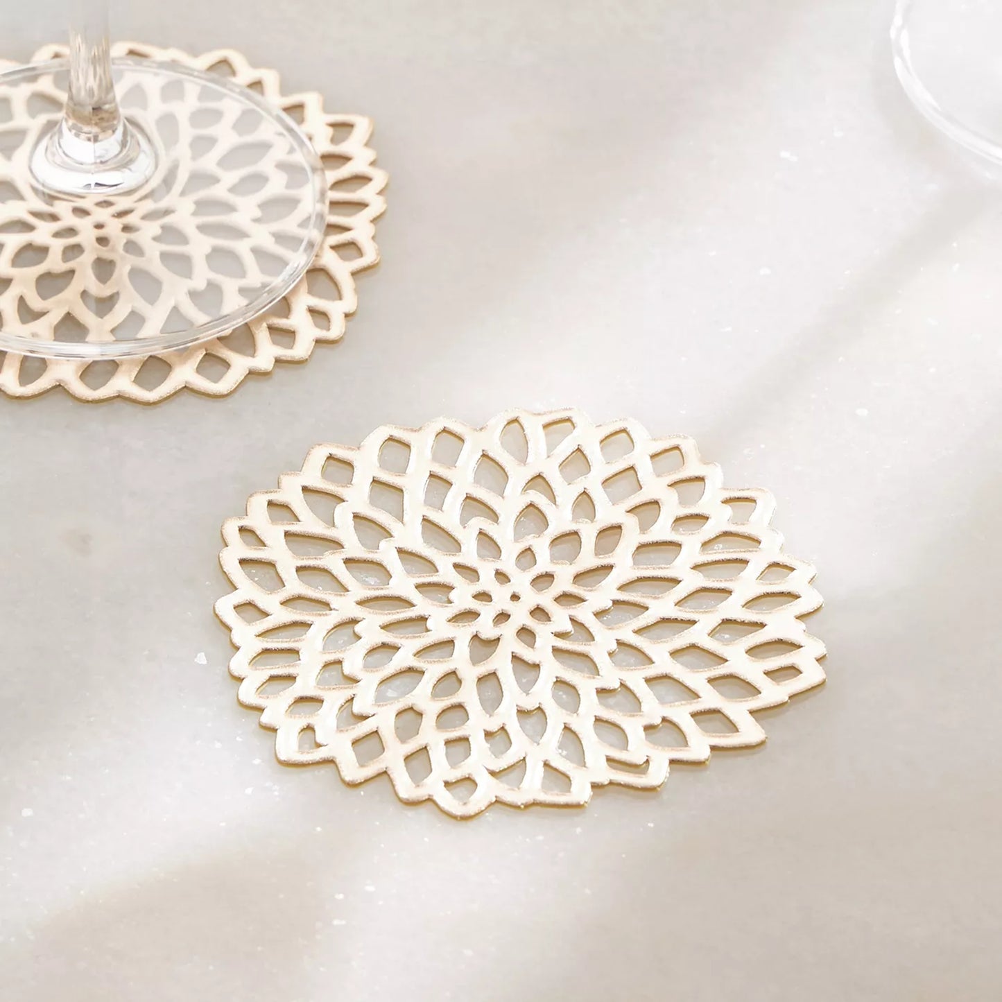 Decorative white lace coasters on a light surface