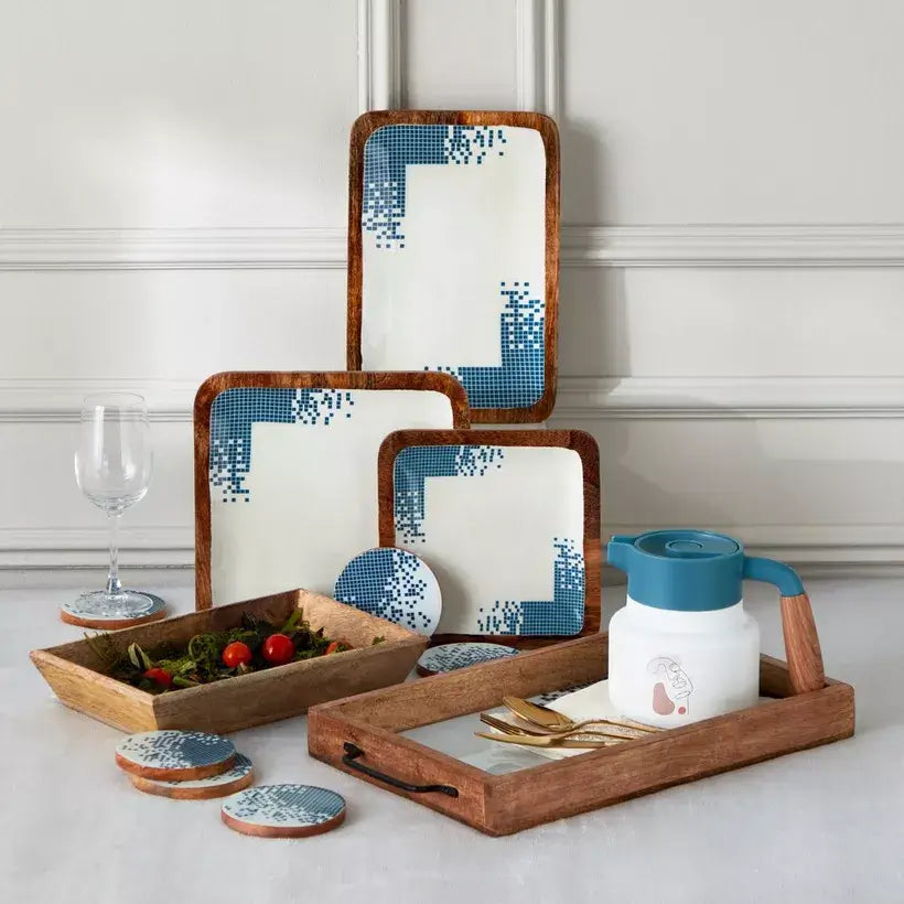 Set of wooden trays with blue and white patterned coasters on a light gray surface.