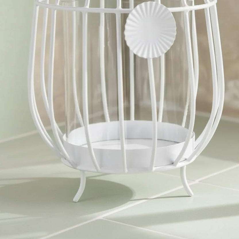 White decorative birdcage on a beige surface