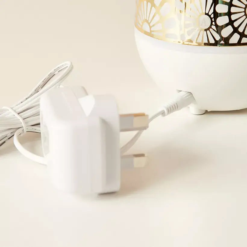 White power adapter with cable on a light beige surface