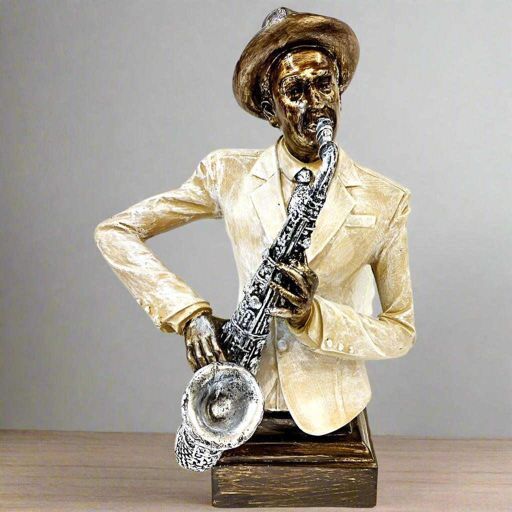Statue of a man playing a saxophone on a wooden surface with a gray background