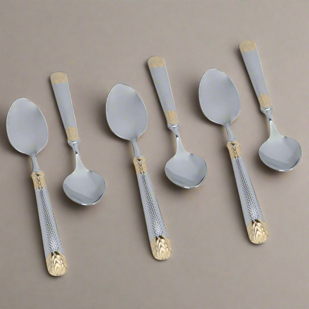 Set of six spoons with decorative handles on a white background