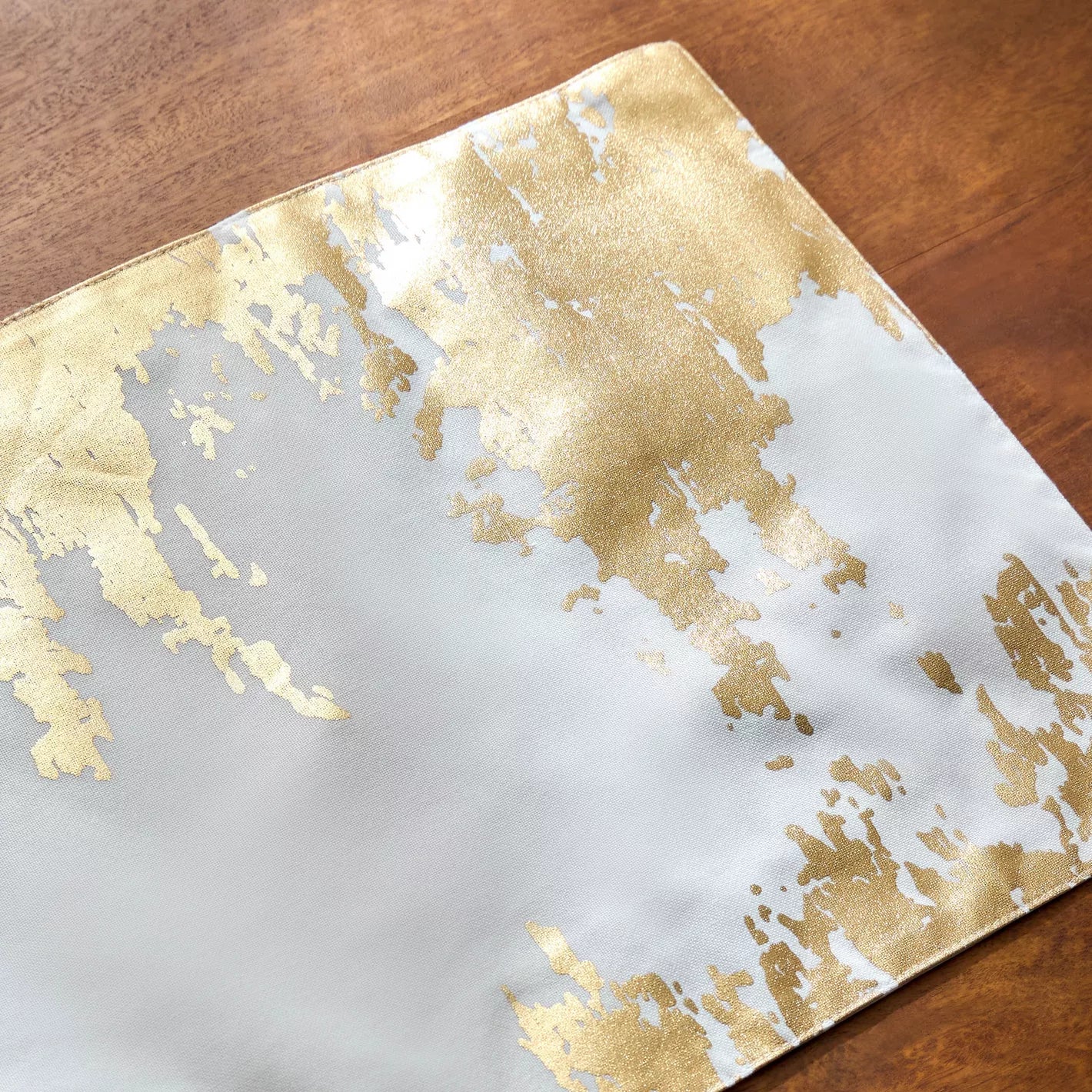 Gold leaf pattern on a white background