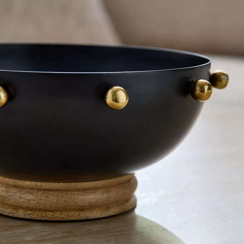 Modern Contrast: Black Metal Bowl with Gold Accents & Wood Base