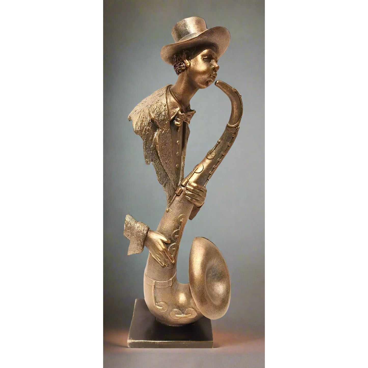 Bronze sculpture of a person playing a saxophone against a gray background