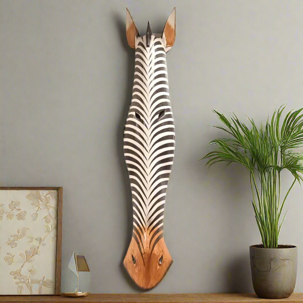 Wooden zebra head wall decoration on a gray wall with a plant and framed picture.