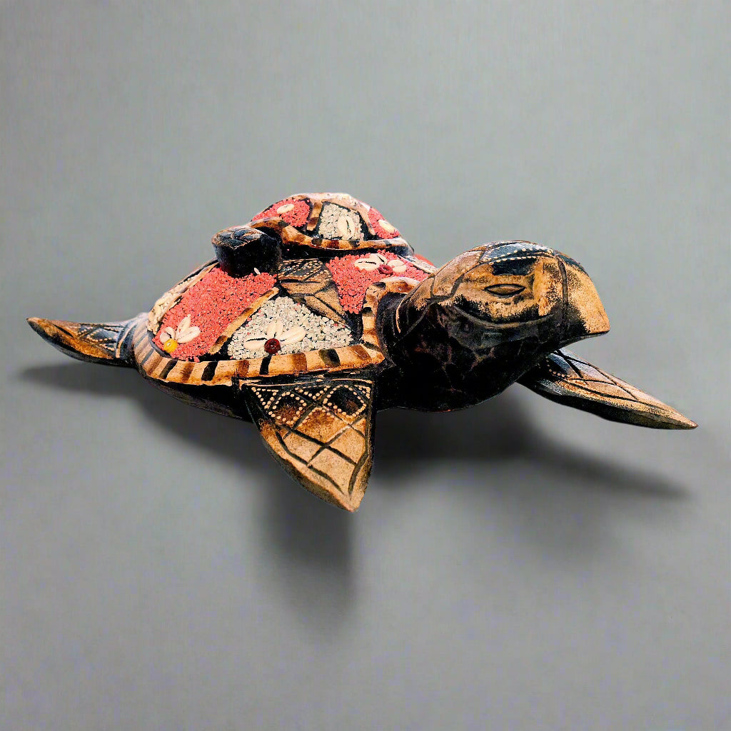 Decorative turtle sculpture with mosaic pattern on a gray background
