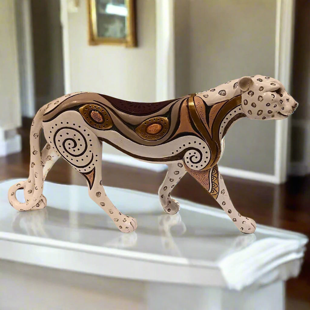 Decorative animal figurine on a white surface with a blurred background
