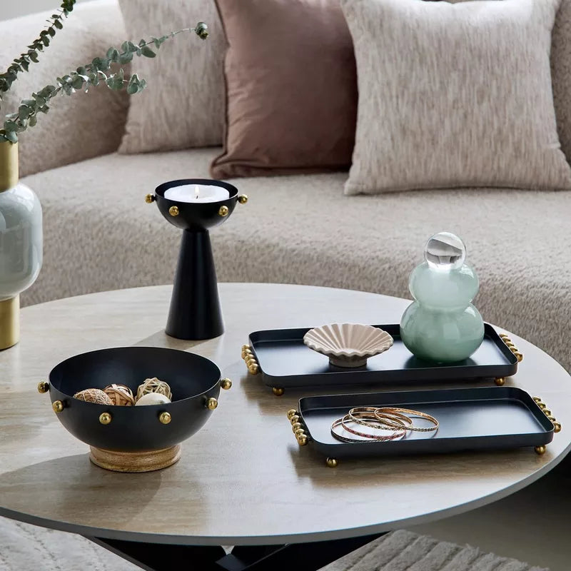 Modern Contrast: Black Metal Bowl with Gold Accents & Wood Base