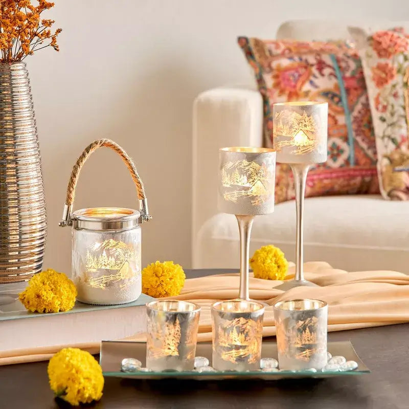 Decorative candles and lanterns on a table with a cozy living room background