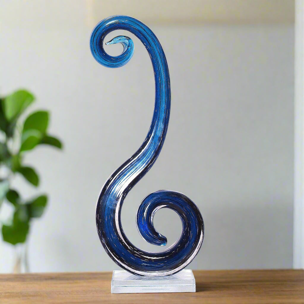 Blue glass sculpture on a white background
