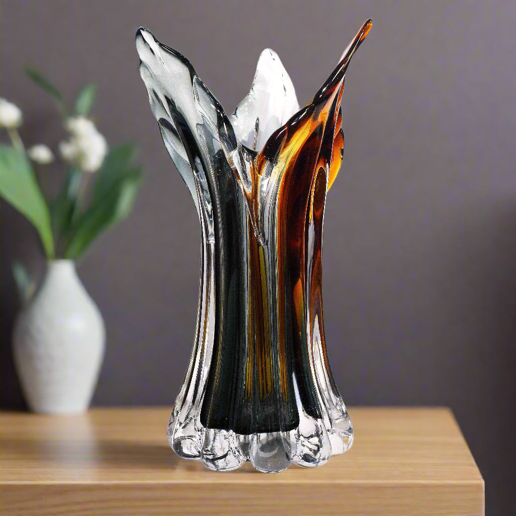 Artistic glass vase with multicolored design on a white background