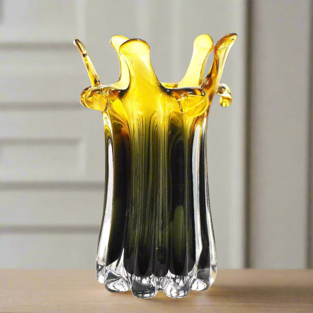 Glass vase with yellow and black gradient on a white background