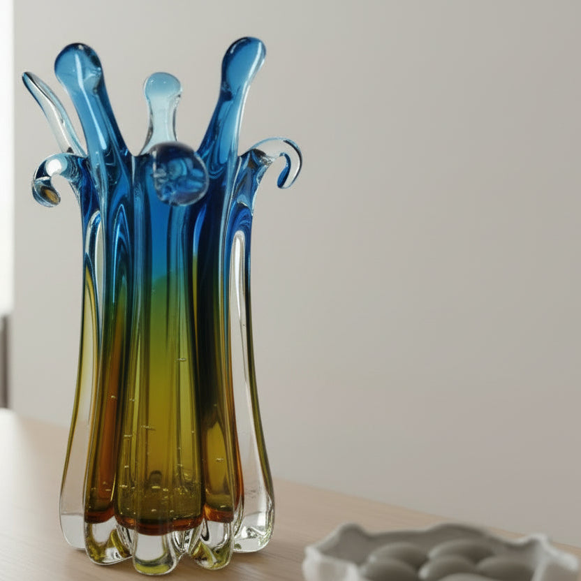 Colorful glass vase with a gradient from blue to green on a white background