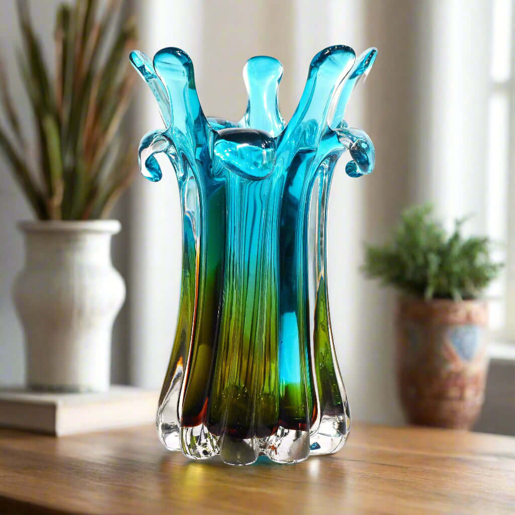 Turquoise and green glass vase on a white background