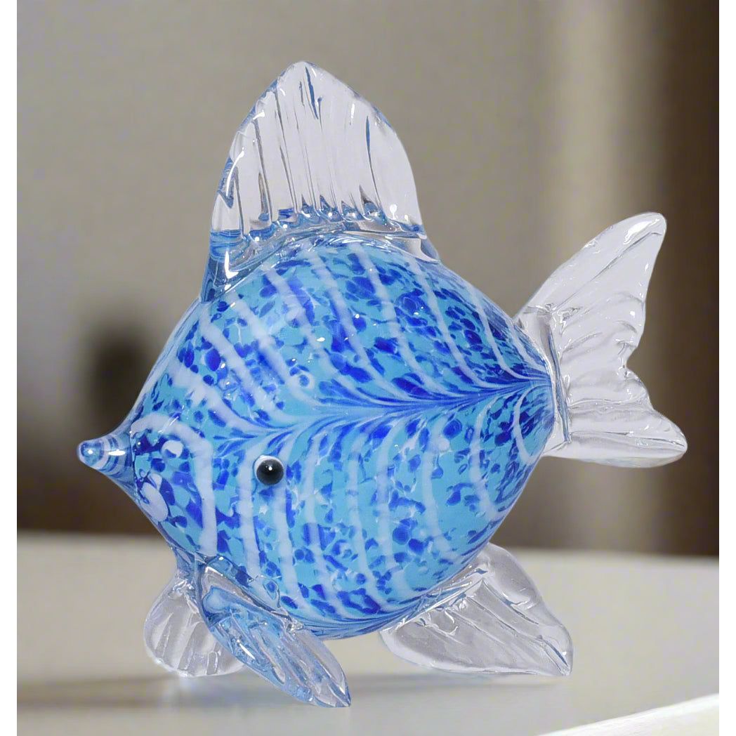 Glass fish figurine with blue and white pattern on a light gray background