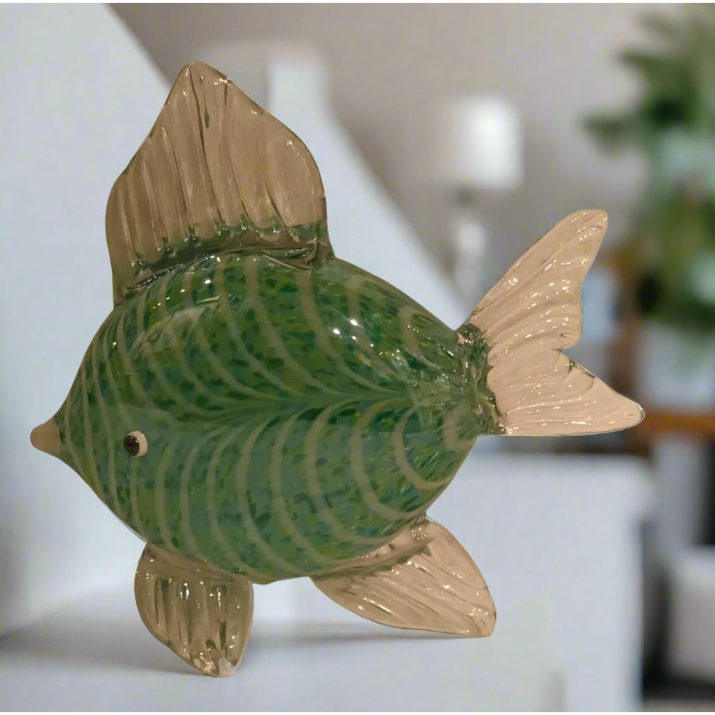 Decorative fish-shaped object with green and beige colors on a light gray background
