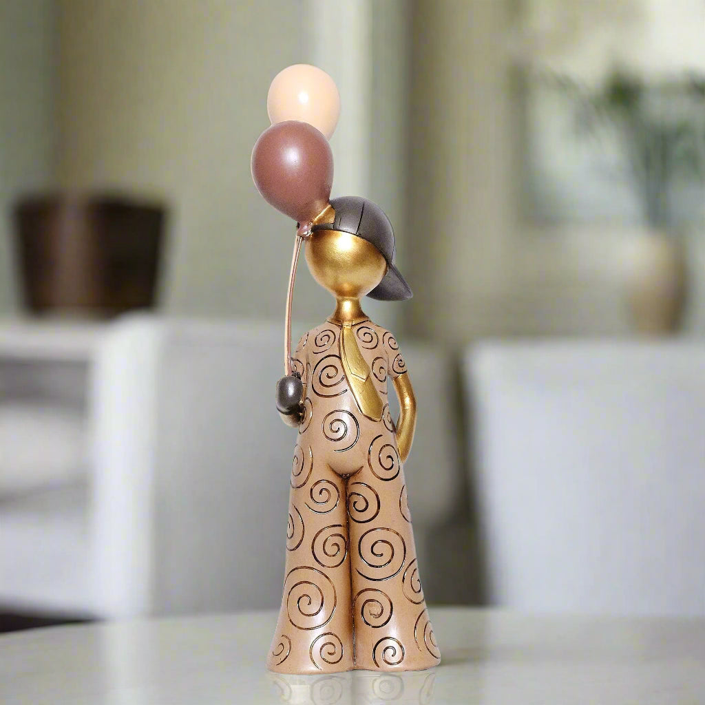 Decorative figurine of a person with balloons on a blurred background