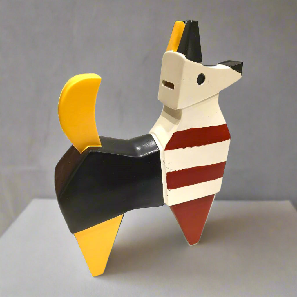 Colorful dog-shaped object with black, yellow, red, and white on a gray background