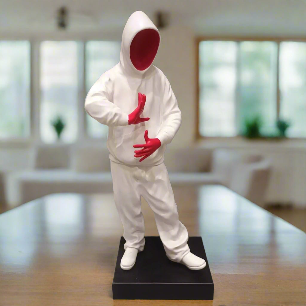 Statue of a person in a white outfit with red gloves and face in an indoor setting