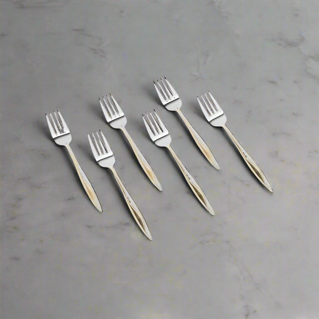 Set of six silver forks with wooden handles on a white background