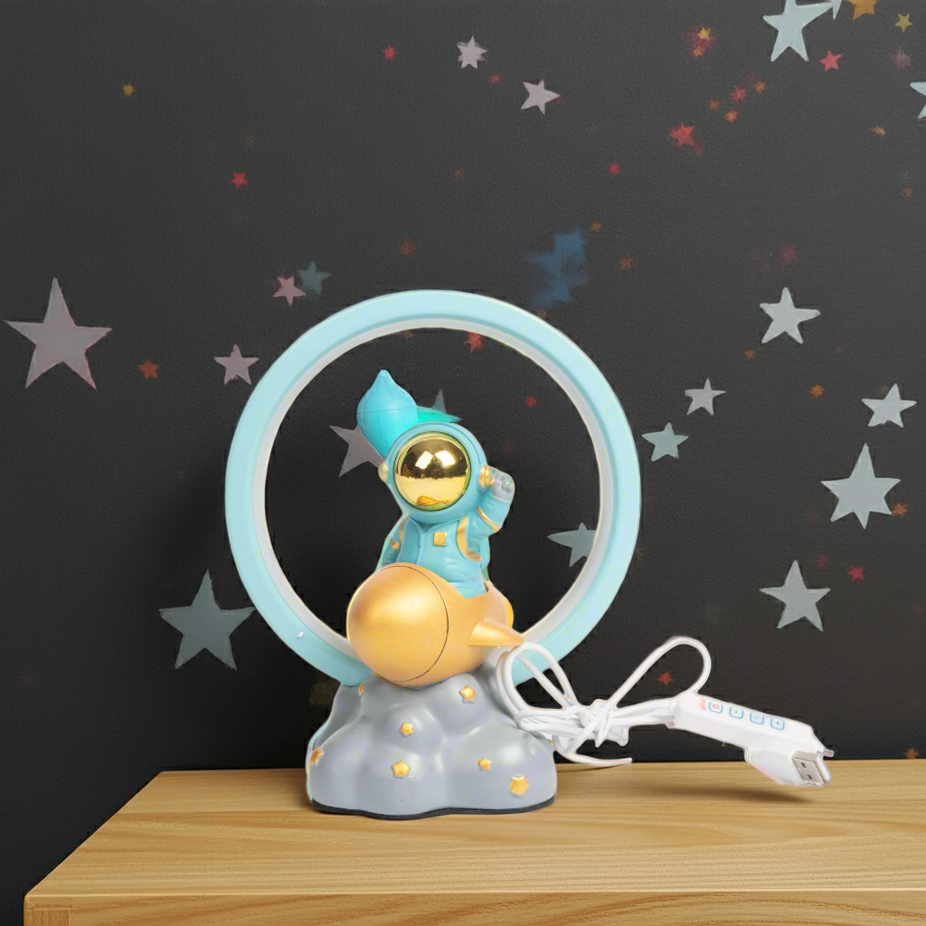 Children's lamp with an astronaut design on a wooden surface against a starry background