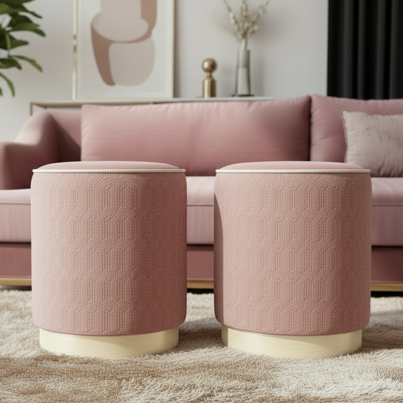 Two pink textured stools in front of a pink sofa in a living room setting.