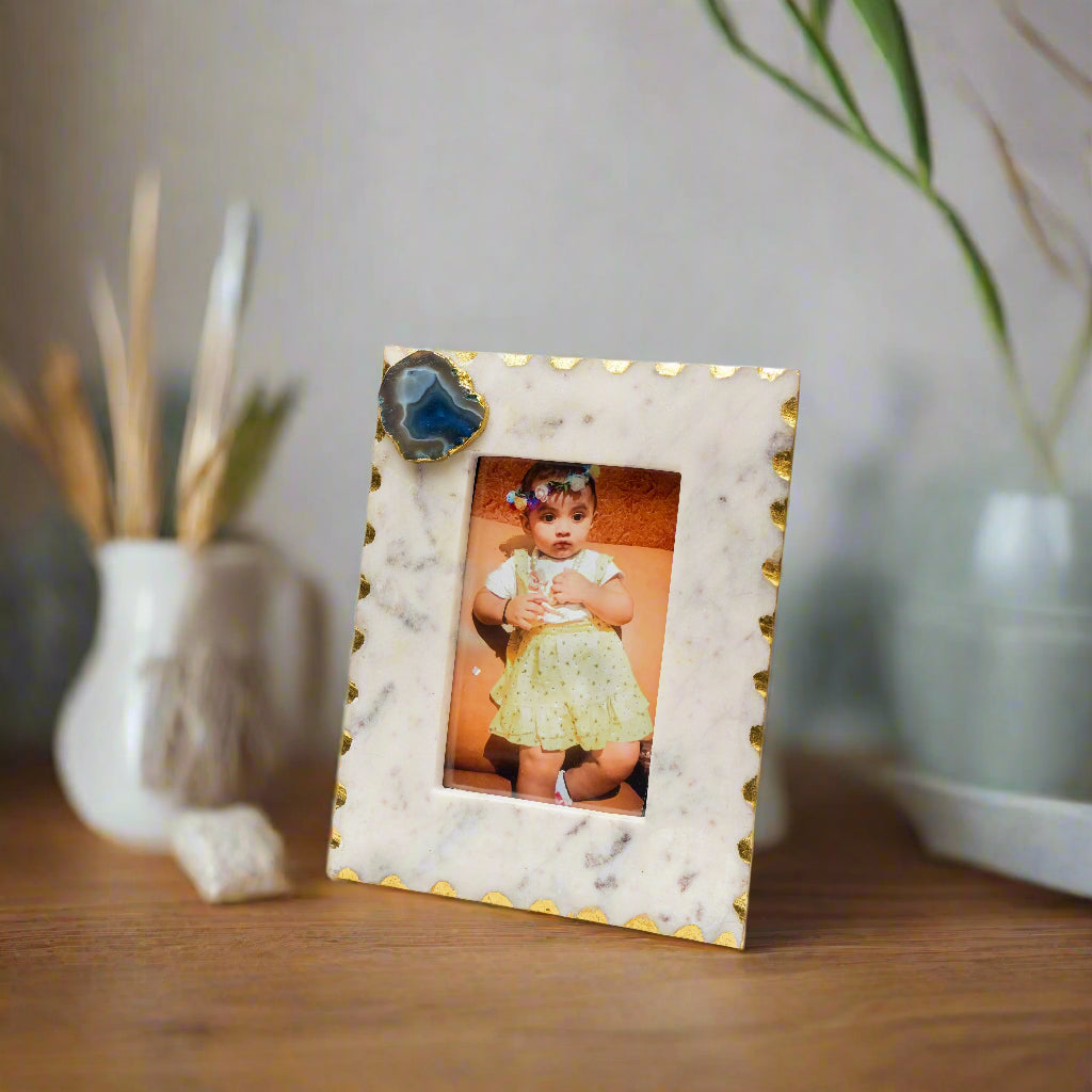 Marble-patterned picture frame with a photo of a child on a white background