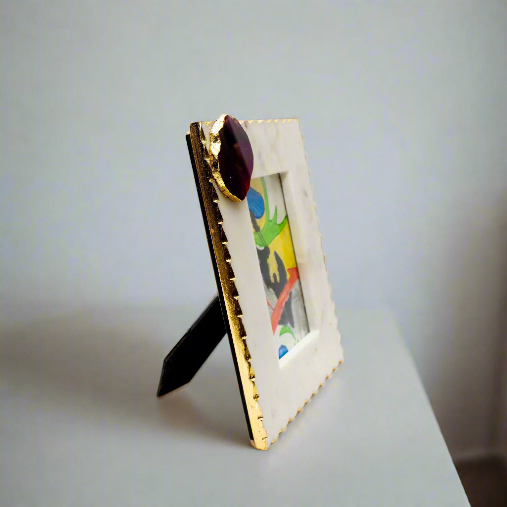 Decorative picture frame with gold accents on a white background