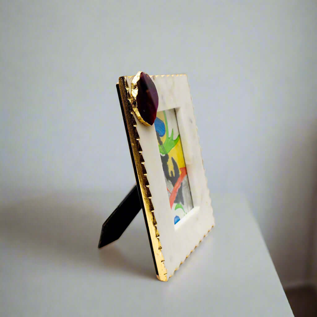 Decorative picture frame with gold accents on a white background