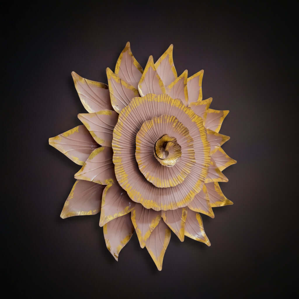 Decorative wall art with pink and gold flower design on a light background
