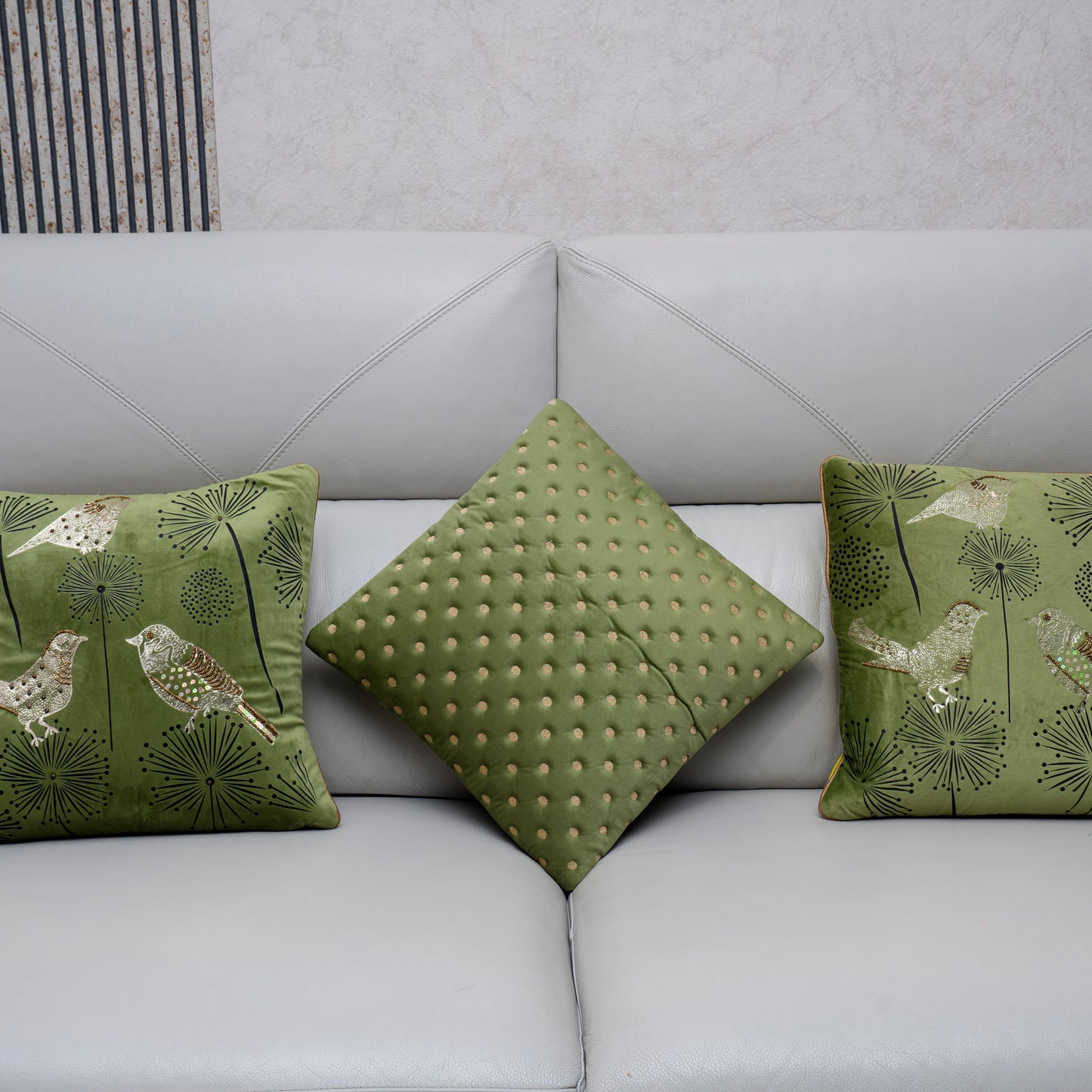 Green patterned cushions on a light gray sofa
