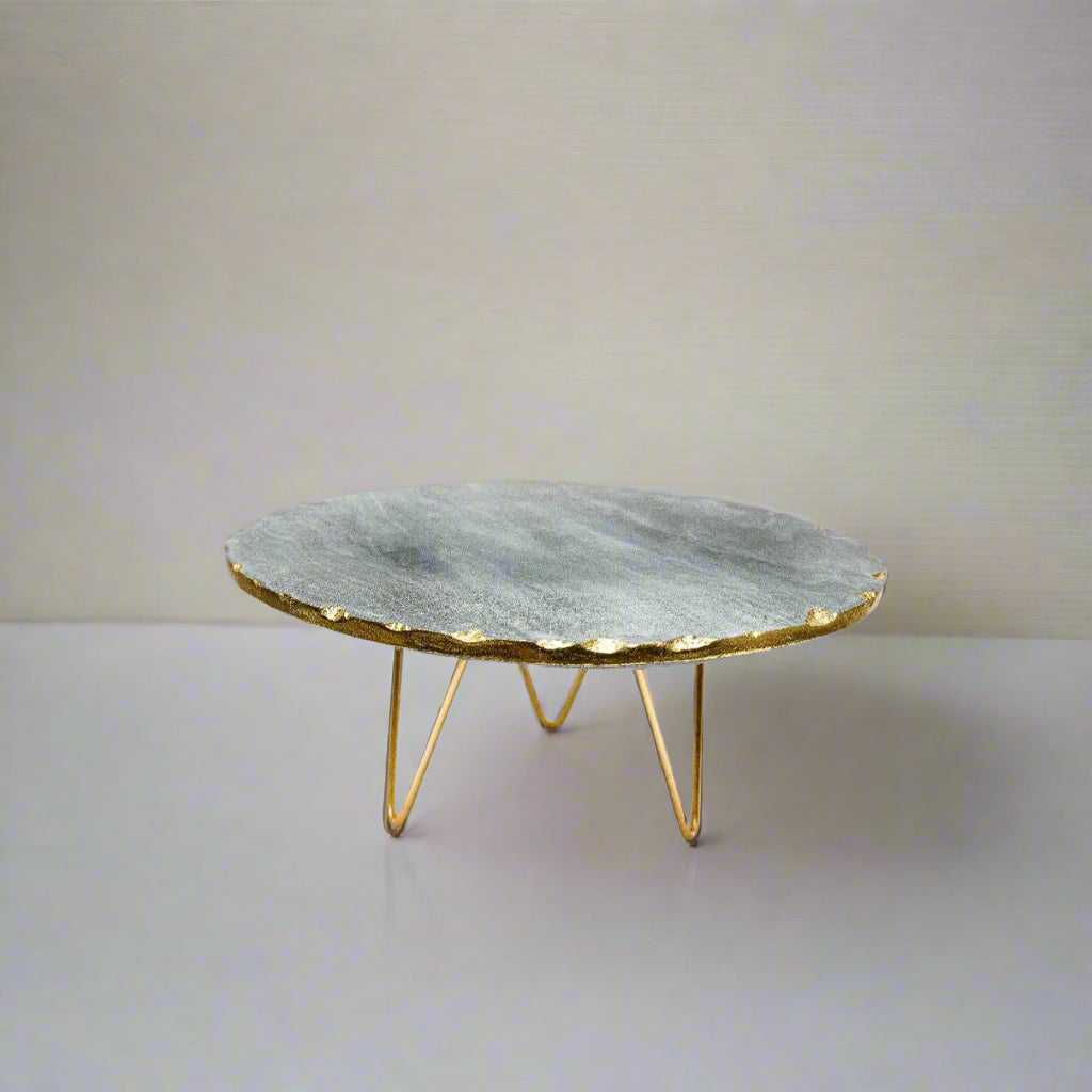 Marble coffee table with gold base on a white background