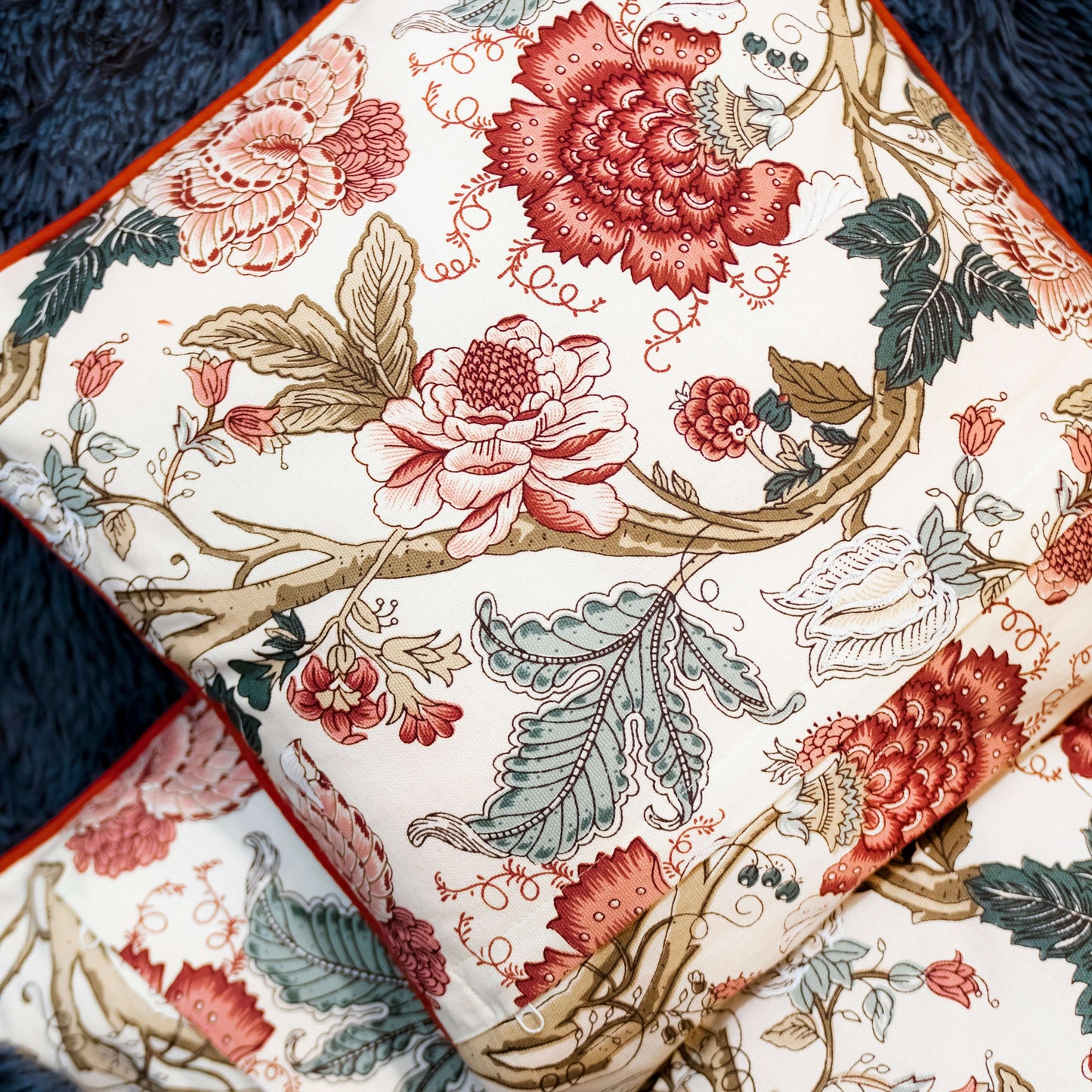 Red Floral Vintage Botanical Accent Cushion Cover with Floral patterned fabric with red and green colors on a white background