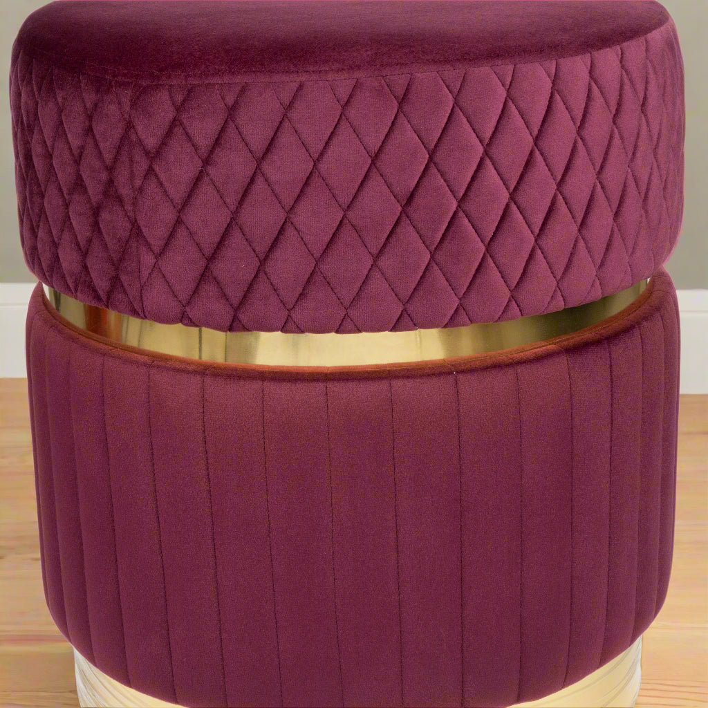 Purple quilted stool with a gold band on a white background