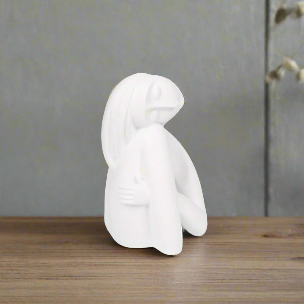 White ceramic horse figurine on a white background