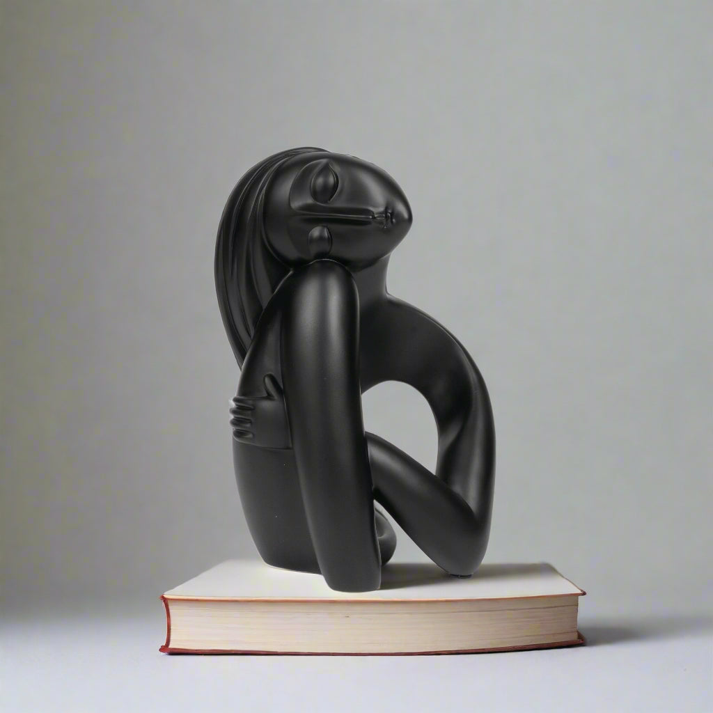Black abstract sculpture on a white background