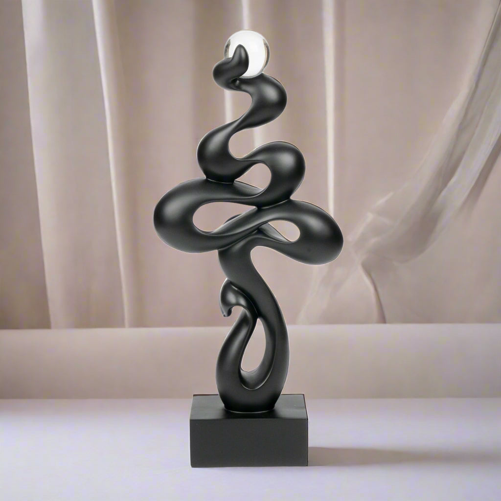 Black abstract sculpture on a white background