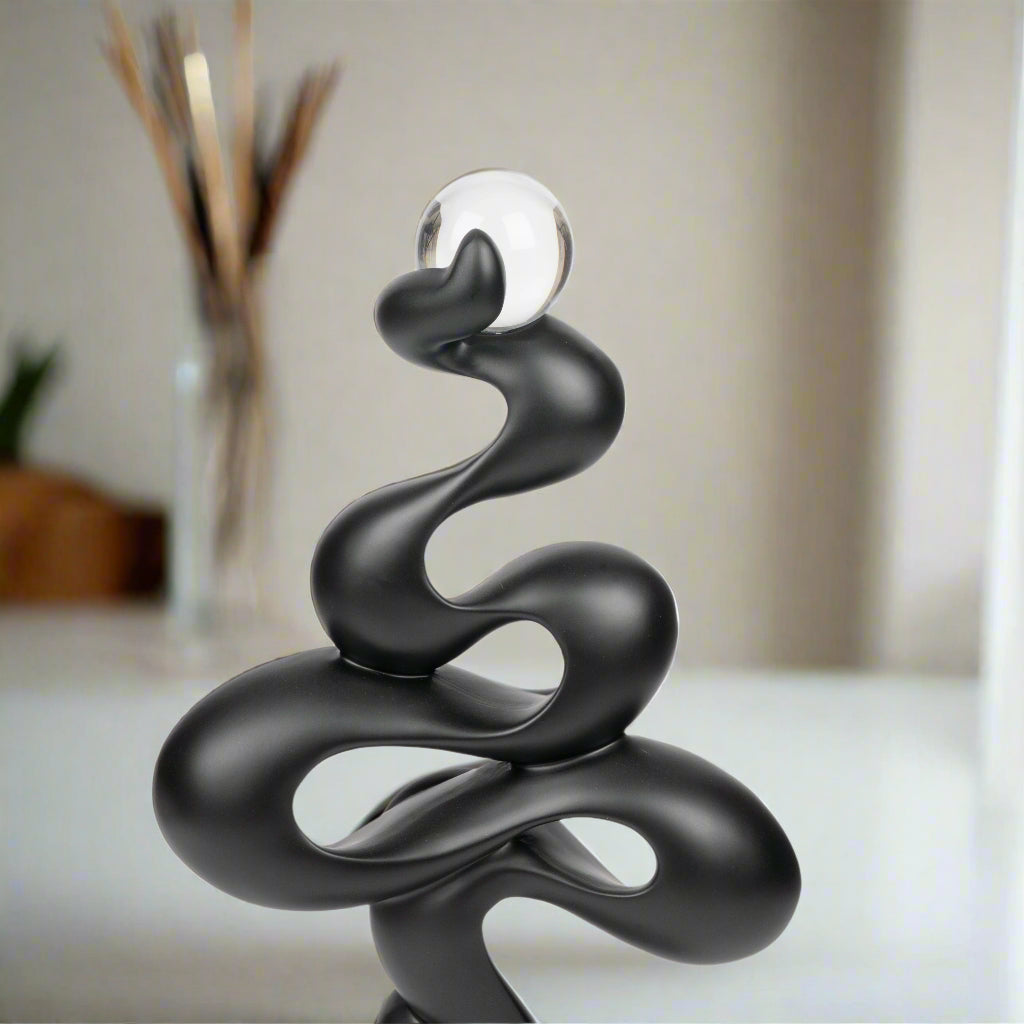 Black abstract sculpture on a white background