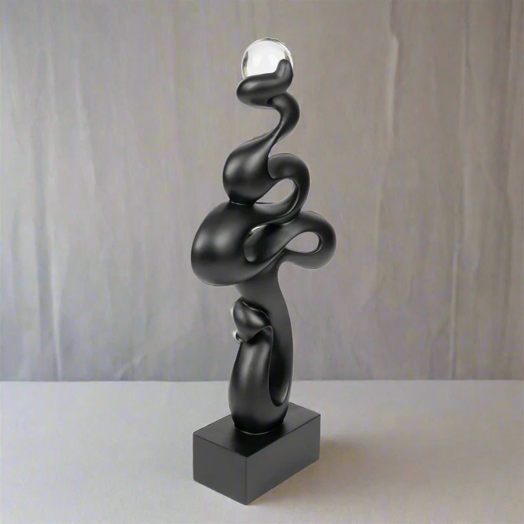 Black abstract sculpture on a white background