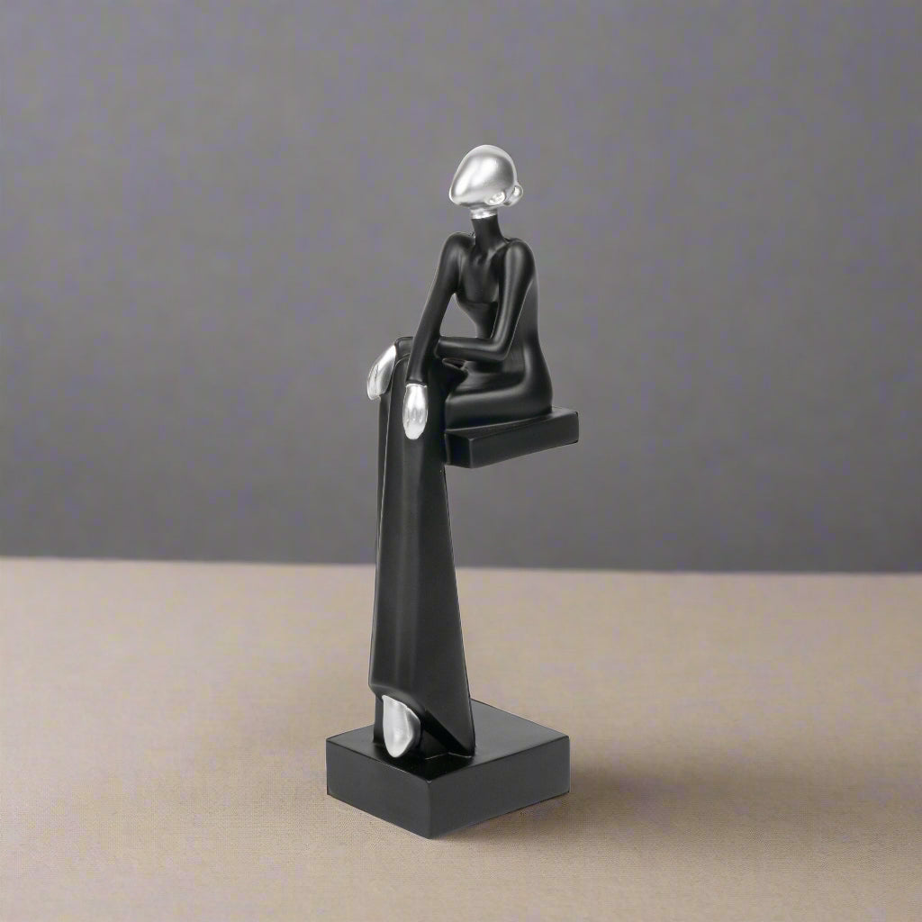 Black and silver abstract sculpture on a white background