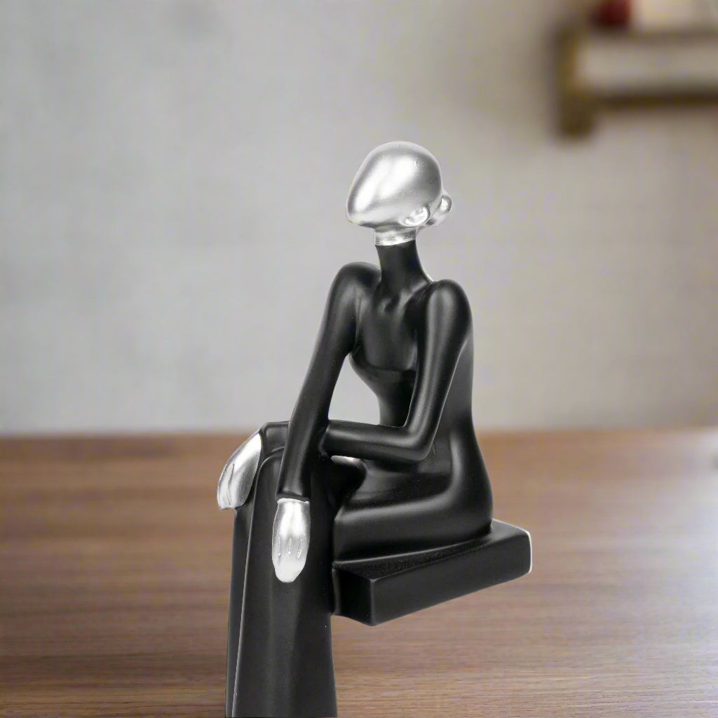 Sculpture of a person with a metallic head on a white background