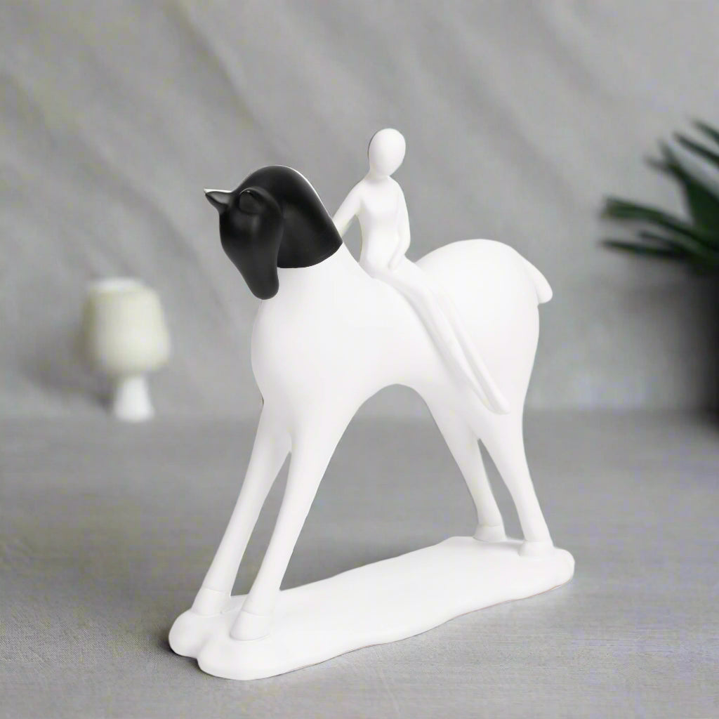 White and black ceramic figurine of a couple on a white background