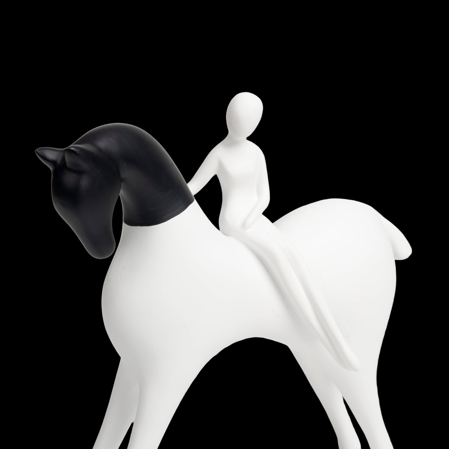 White horse figurine with a black head on a light gray background