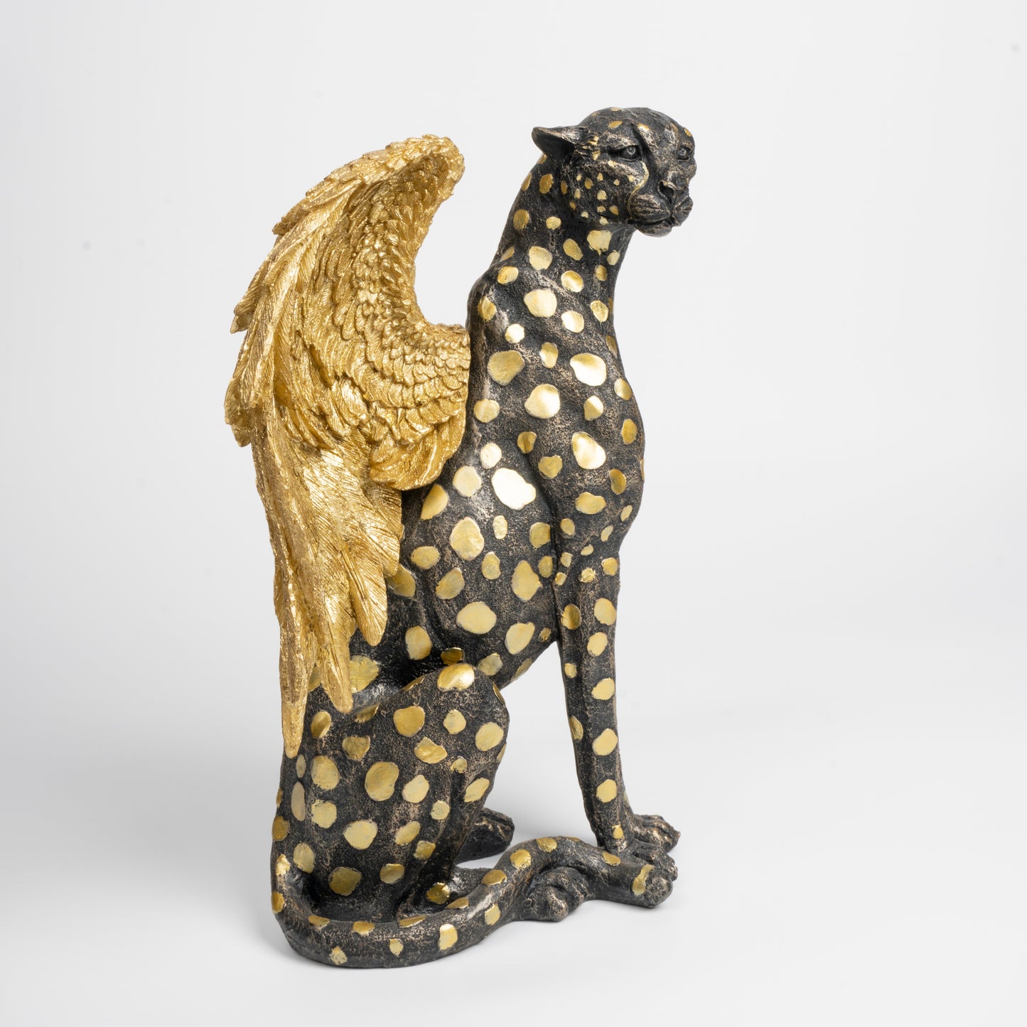 Statue of a panther with gold wings on a white background
