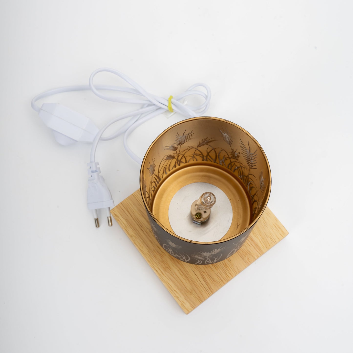 Decorative lamp with wooden base and floral design on a white background
