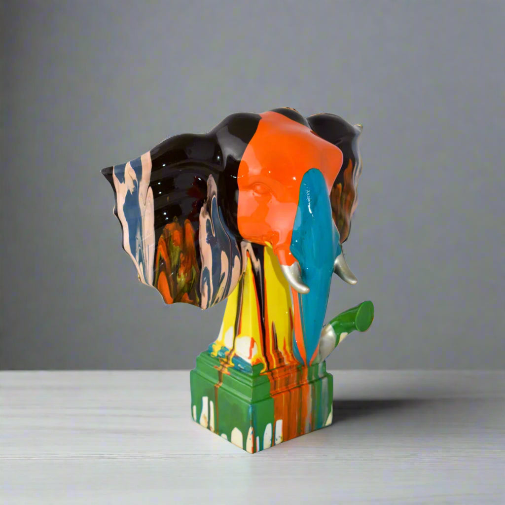 Colorful elephant sculpture on a light gray surface